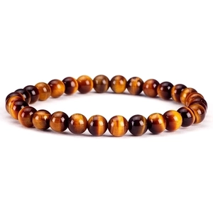 Macro shot of 6mm tiger eye stone beads showing polished amber texture and natural luster