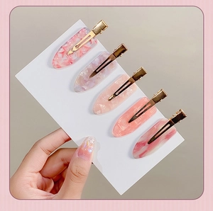Set of five gold hair clips with pink marble oval acetate resin patterns