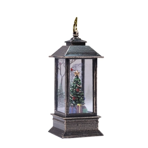 Antique bronze Christmas lantern with miniature Christmas tree and star topper inside