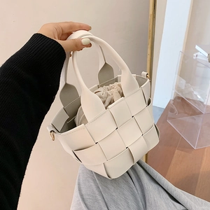 Chic white woven mini bucket bag featuring PU leather texture and a drawstring pouch insert
