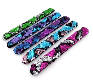 Detail of colorful reversible mermaid sequins on adjustable slap bracelets for kids