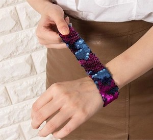 Detail of mermaid sequin slap bracelet featuring a purple and blue reversible heart pattern
