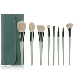 Detailed set of 8 green makeup brushes with soft bristles and matching faux leather case