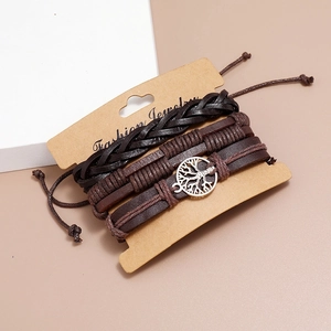 Detail of vintage braided leather bracelets with Tree of Life charm on display card