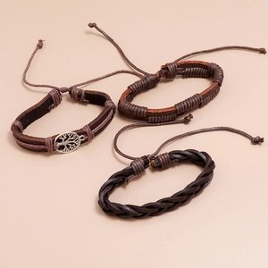 Detailed view of handmade braided leather bracelets set with Tree of Life metal charm