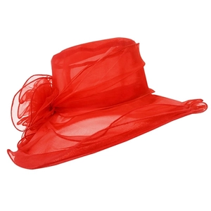 Detail of red mesh sun hat showing elegant large floral decoration and sheer fabric