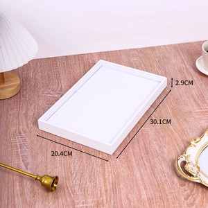 White rectangular jewelry display tray 30.1x20.4x2.9cm on a wooden table with home decor
