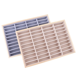 Wooden jewelry trays with grey and beige velvet inserts for organizing bangles and rings