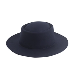 Detailed texture of dark blue wool felt hat with flat top and smooth matte finish