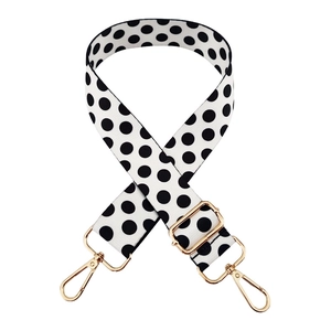 Adjustable black and white polka dot woven bag strap with golden metal hooks