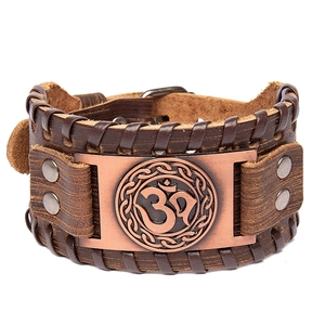 Vintage brown leather Viking cuff bracelet featuring a bronze Celtic Om symbol emblem