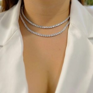 Double layered silver tennis necklace with micro-paved zircons worn by a male model