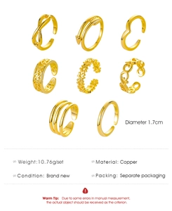 Detail view of 8-piece adjustable gold toe rings set in copper with varied engraved patterns
