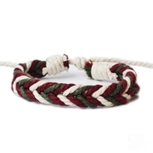 Detailed view of handmade woven braid bracelet in dark red, green, and cream colors
