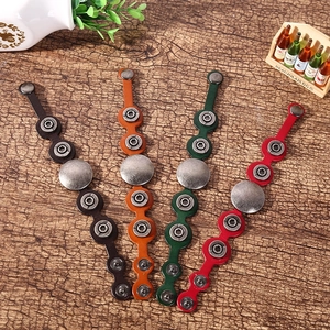 Genuine leather cable organizers in four colors with vintage metal snaps on wood background