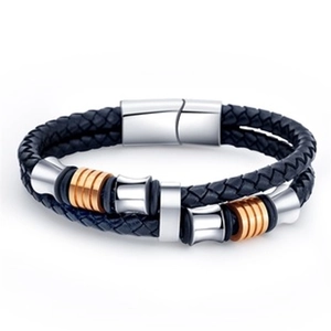 Detail of double-layer woven black leather bracelet with gold and silver magnetic clasp
