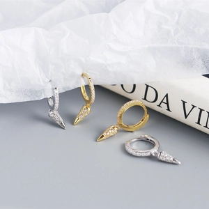 Detail of silver and gold geometric cone drop earrings with sparkling pavé crystals