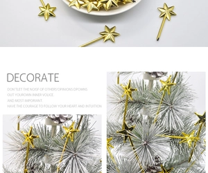 Detail of gold pentagram wand ornaments decorated on a white flocked Christmas tree