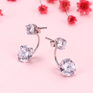 Elegant S925 sterling silver stud earrings with double cubic zirconia on pink background