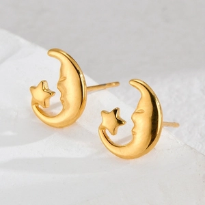 Polished 18K gold stainless steel star and moon earrings on a white stone base
