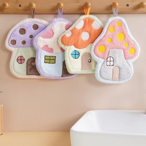Absorbent mushroom shaped coral fleece hand towels in four colors hanging in a bathroom