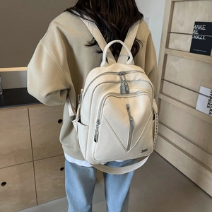 Detail of off-white lychee grain leather backpack with metallic logo and zippers