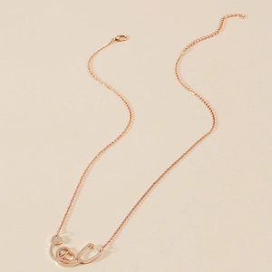 Macro view of rose gold stethoscope heart pendant necklace with adjustable chain links