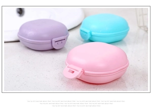 Detail of travel soap box with secure lid and drainage in pink, blue, and purple colors