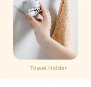 Detail of grey bear towel plug with soft silicone teeth for wall-mounted storage