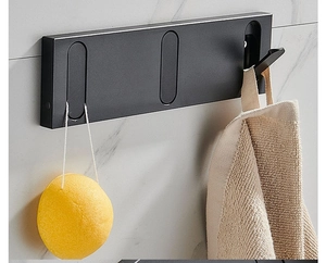 Modern matte black folding wall hooks for towels and bathroom accessories on marble wall