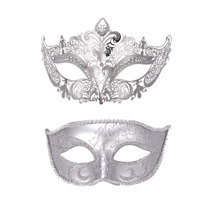Detail of silver masquerade masks set featuring filigree metalwork and glitter patterns
