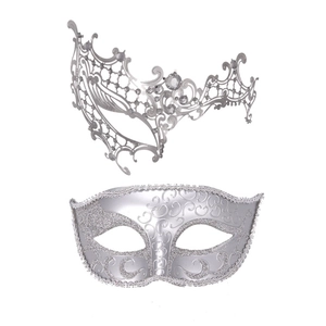 Detail of silver masquerade masks with intricate filigree, rhinestones, and silver glitter