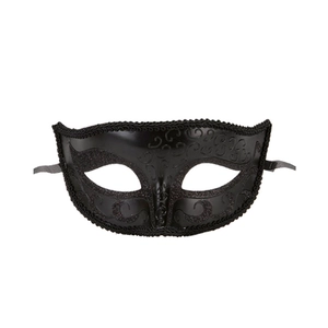 Detail of black laser-cut metal masquerade mask with ornate filigree and side ribbons