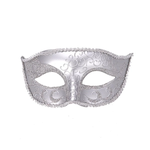 Detail of silver filigree masquerade mask with glitter edges and hollowed eye design