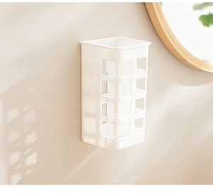 White wall-mounted hair curler holder with hollow design in a cozy bathroom setting
