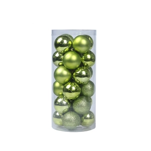 Detail view of various green Christmas balls in matte, glossy, and glitter finishes