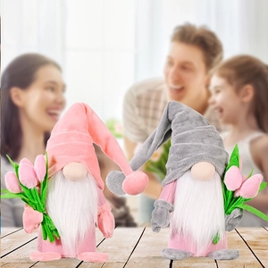Detail of pink and grey plush faceless tulip gnomes on a warm wooden tabletop