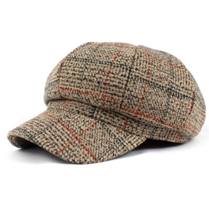 Close-up of brown plaid baker boy hat with classic check pattern and thick wool fabric