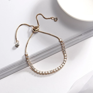 Detail view of gold tennis bracelet with 3mm zircons and adjustable slider closure