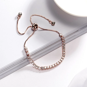Close-up of rose gold tennis bracelet featuring white zircons and adjustable pull clasp