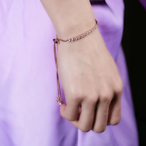 Detail of rose gold adjustable bracelet with 3mm cubic zirconia on purple silk
