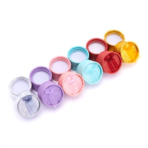 Close-up of colorful round jewelry gift boxes with silk ribbon bows in multiple colors