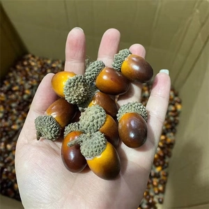 Handful of realistic artificial brown acorns for Christmas home decoration and props