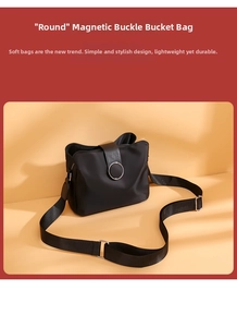 Detailed view of black nylon bucket bag with large metal ring magnetic closure