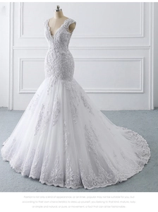 Macro shot of white mermaid wedding dress with deep V-neck, lace embroidery and sequins