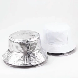 Dual-sided bucket hat detail showing metallic silver texture and plain white fabric contrast