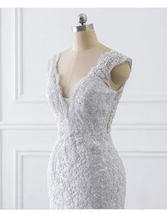 Detailed view of intricate floral lace and sequins on a white mermaid wedding dress