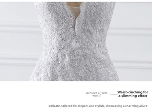 Close-up of white mermaid bridal gown featuring floral lace and sequin embroidery