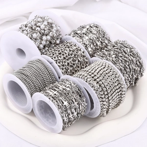 Variety of 7 silver stainless steel DIY jewelry chains in a white tray with soft lighting