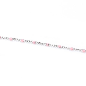 Macro detail of silver stainless steel chain with pink enamel dots for DIY jewelry